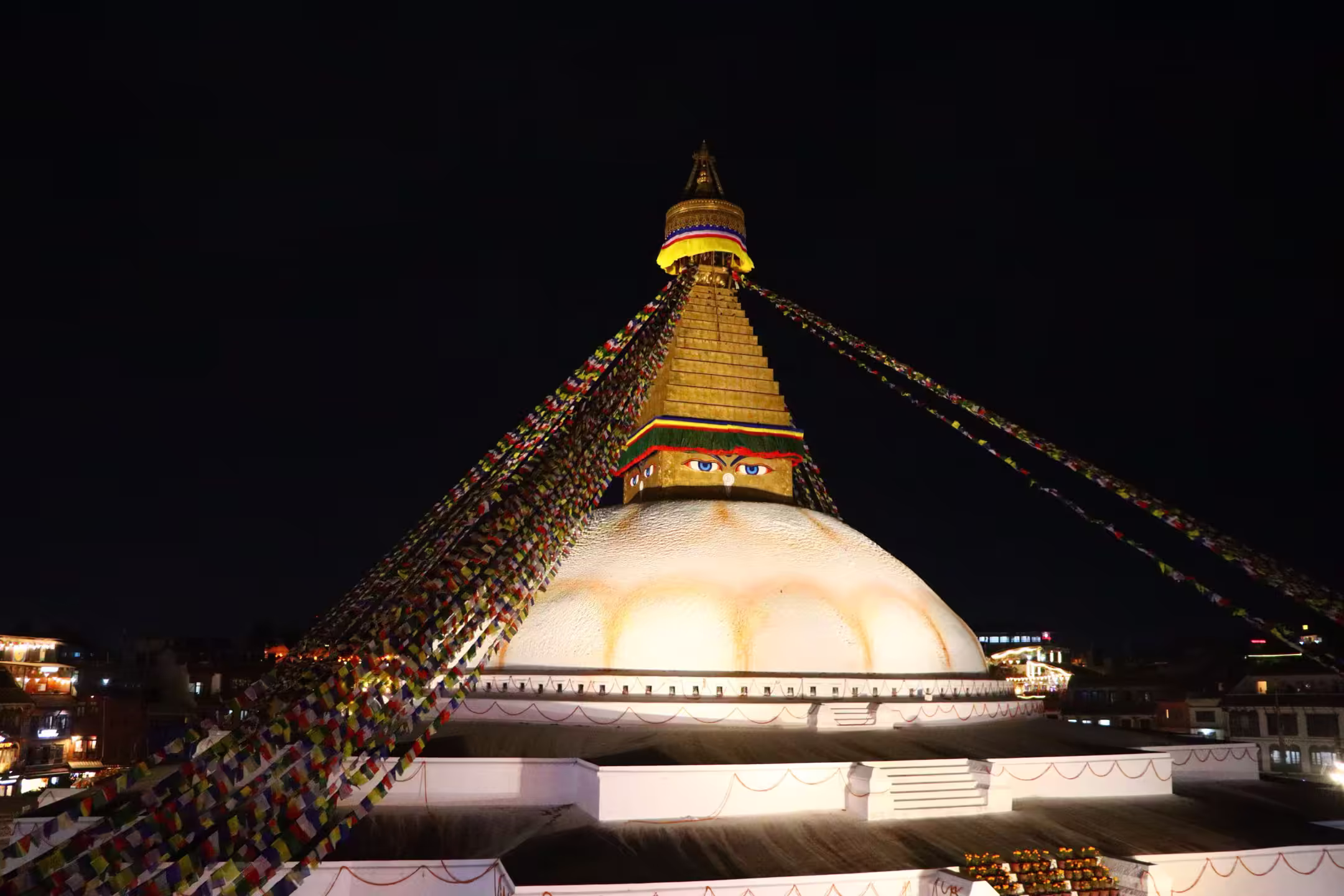 Boudhanath stupa illuminated against the night sky