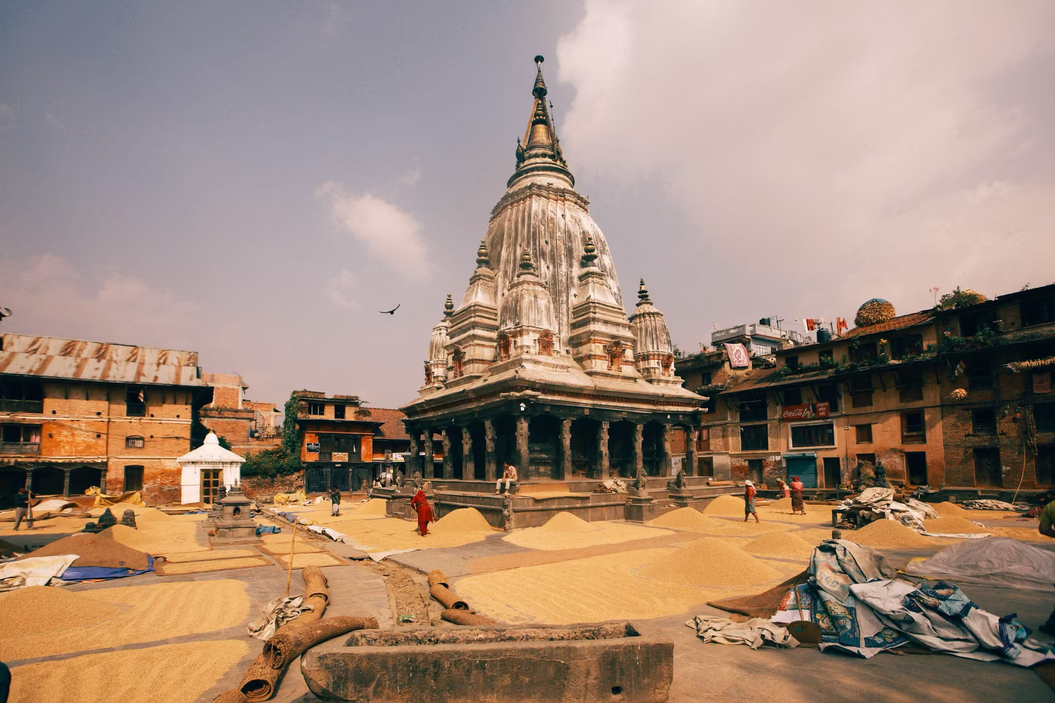 Locals sun-drying grains among the temples of Kathmandu Durbar Square