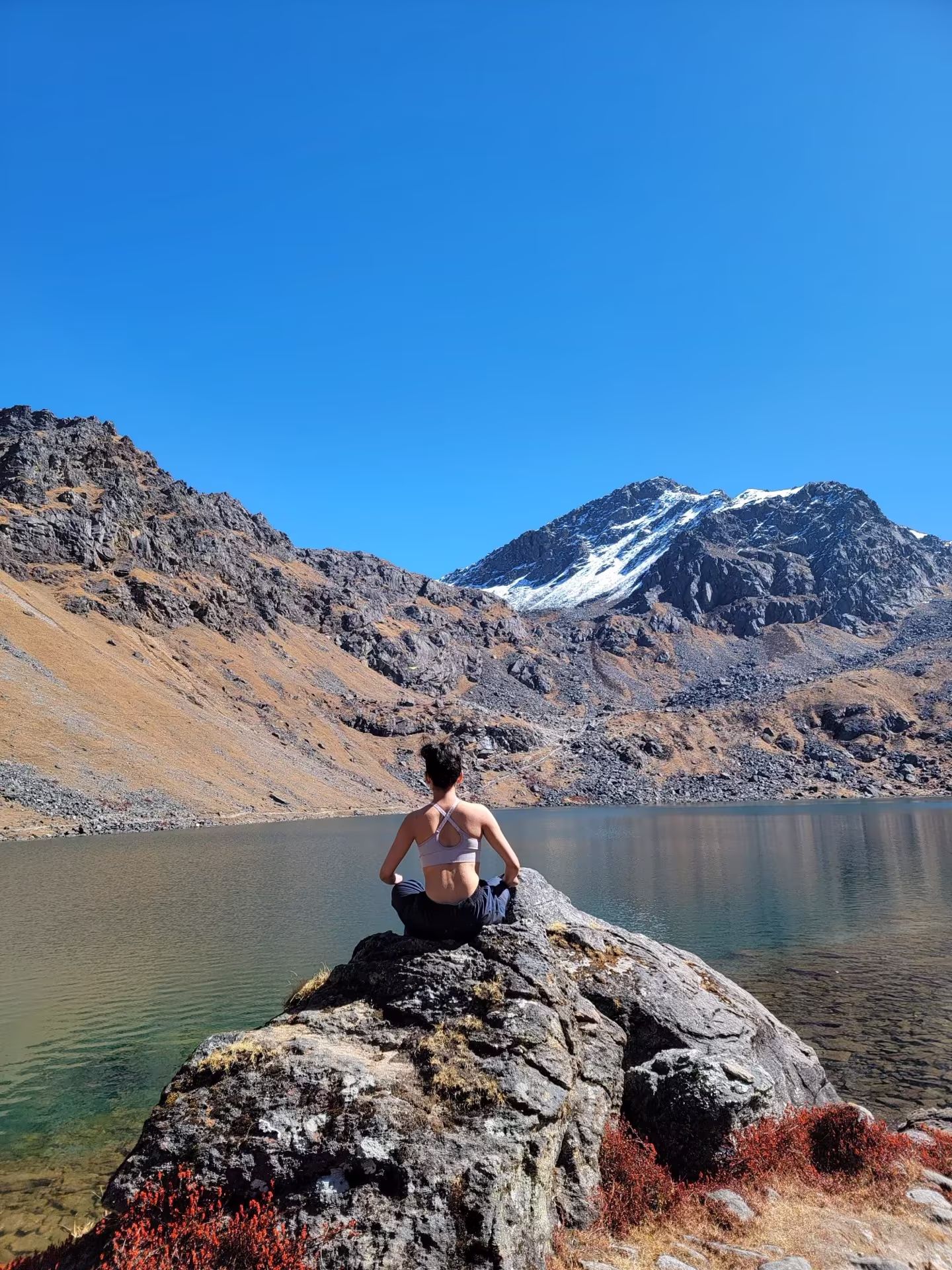 A traveler meditating beside Gosaikunda lake