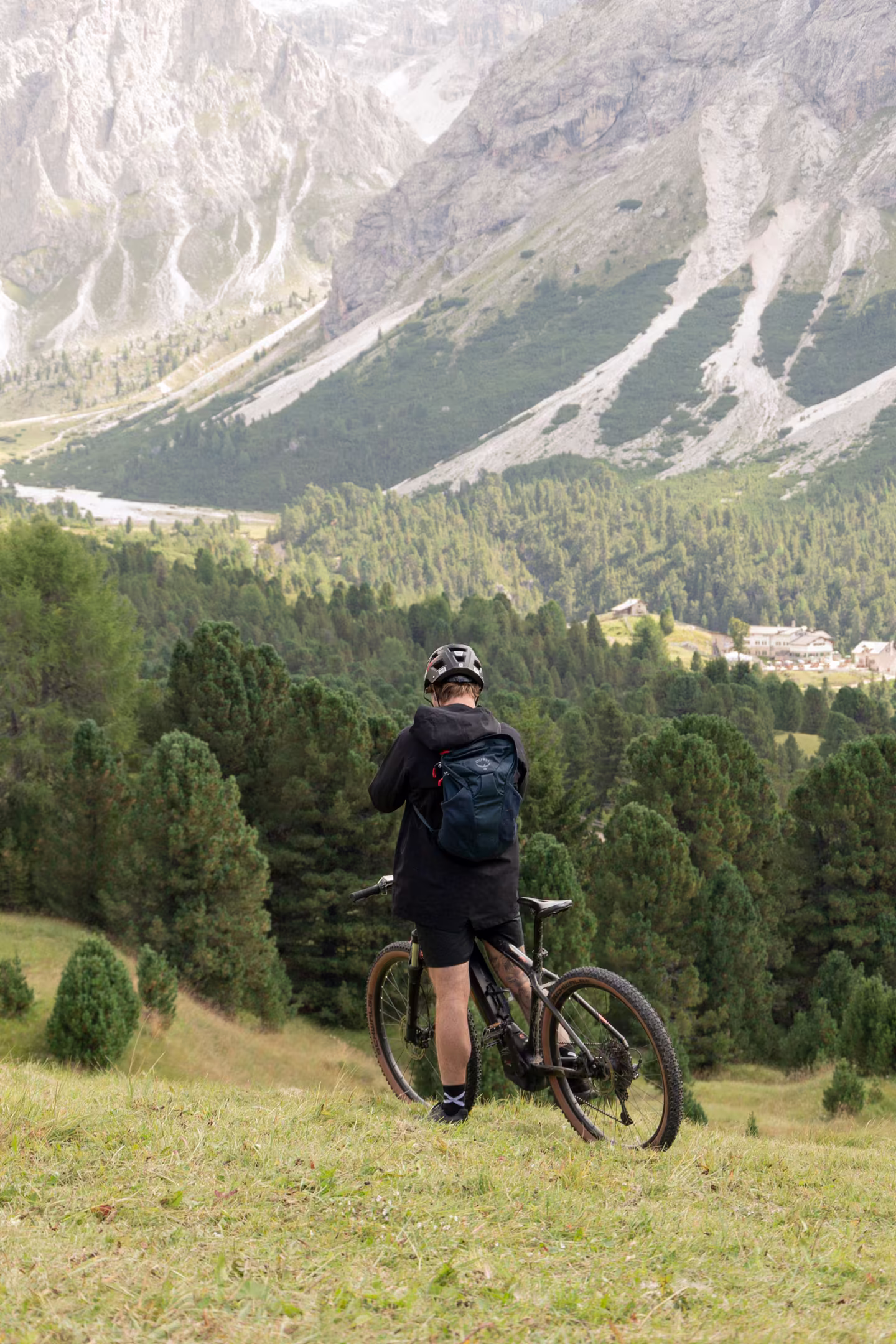 A mountain bike resting on a ridge above a deep Himalayan valley