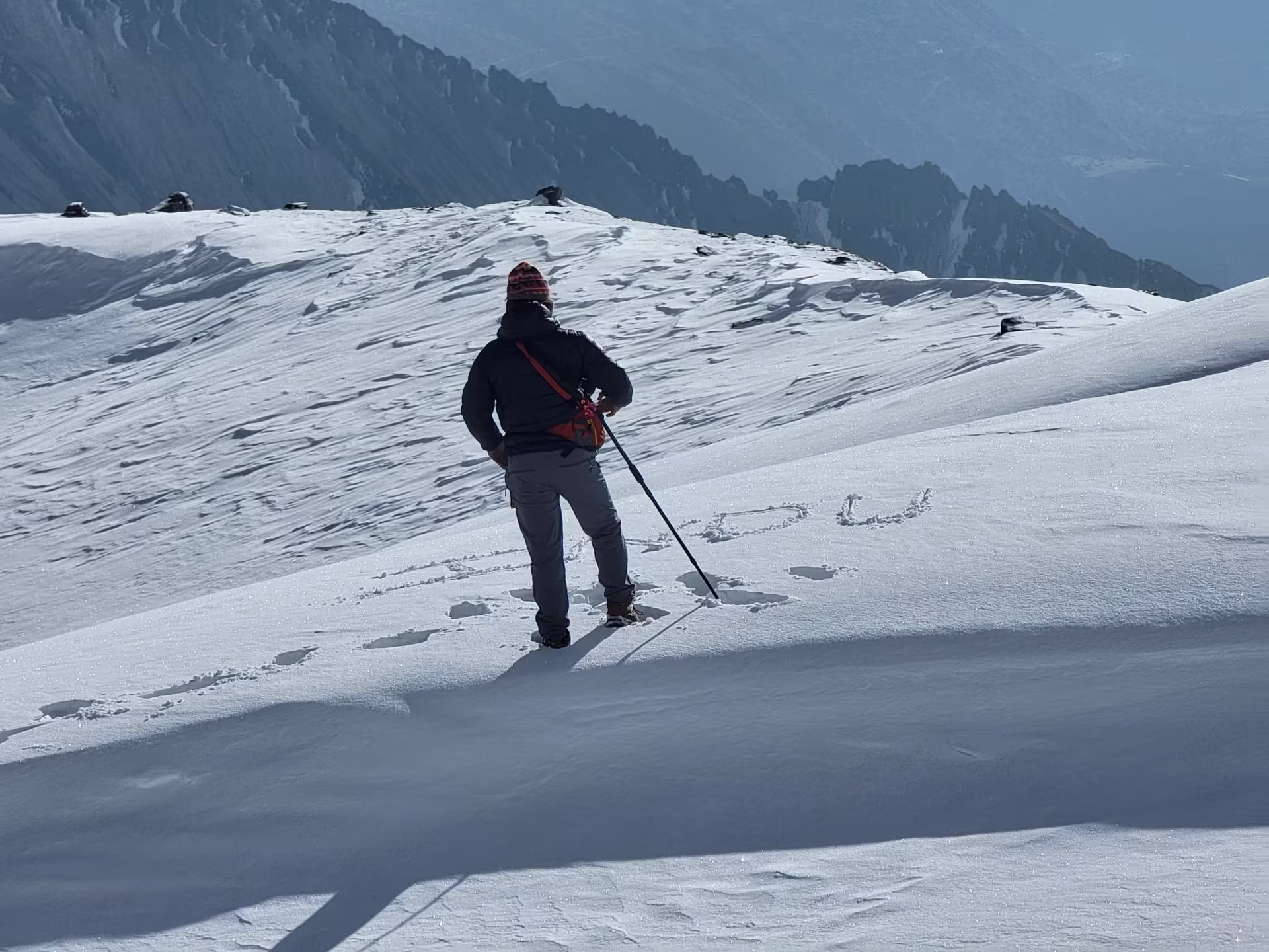 A traveler writing a message in fresh snow