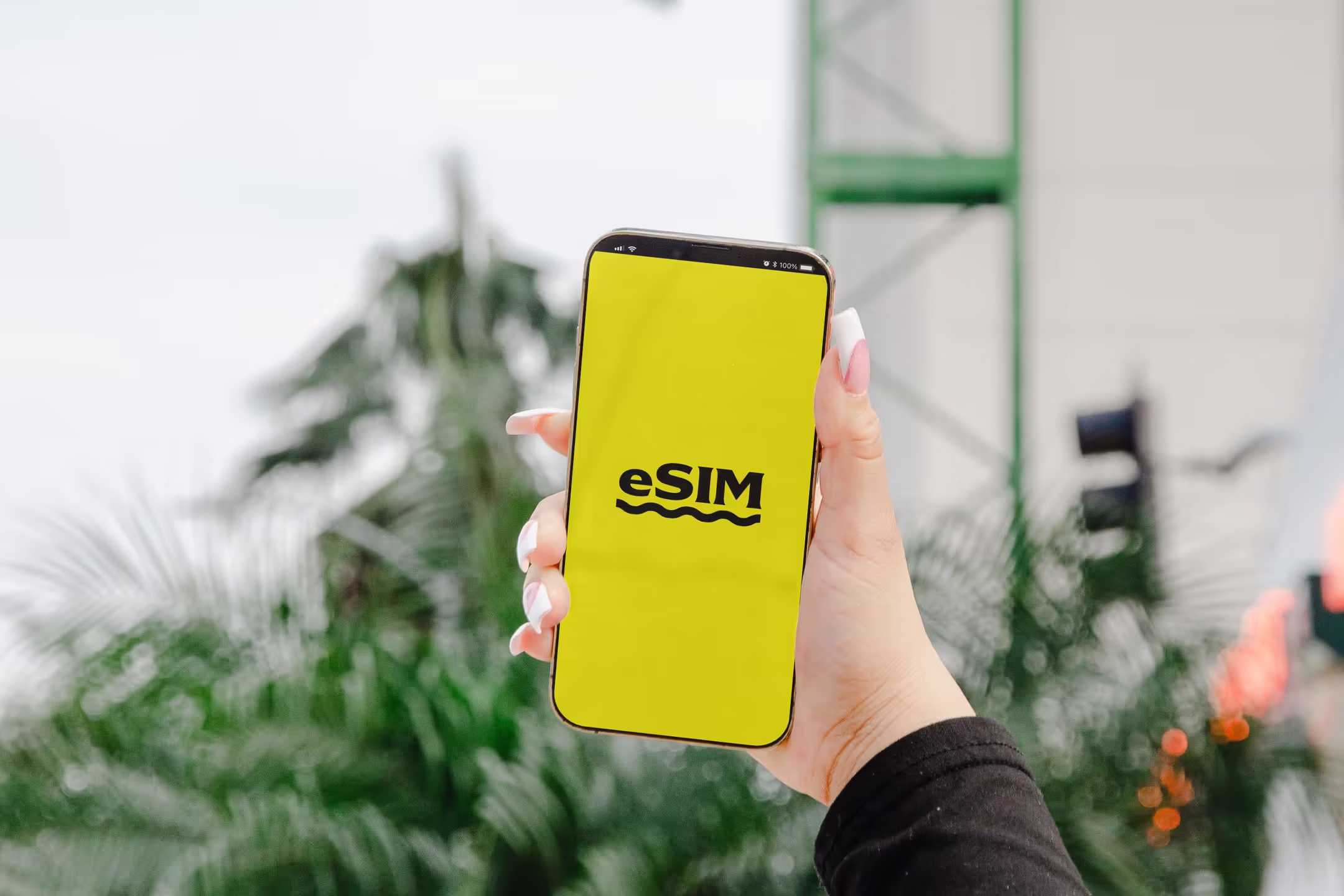 Phone screen displaying eSIM text on yellow background