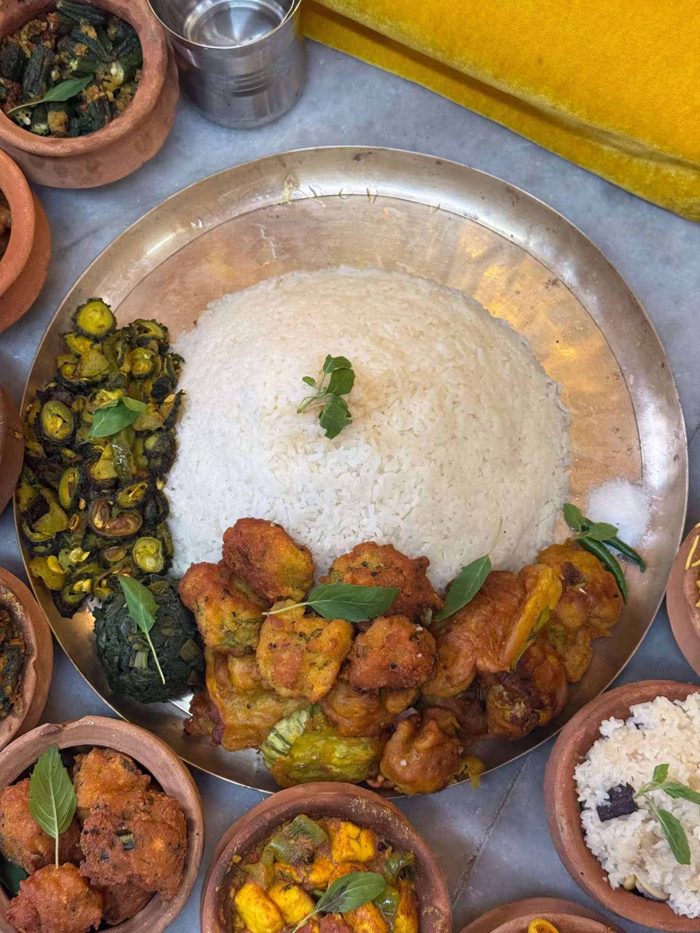 Dal bhat and assorted Nepali dishes served in traditional pottery vessels